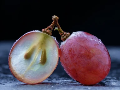 Red grape berries in cross-section revealing valuable seeds rich in OPC antioxidants, which are part of Roanga ATU for cardiovascular health support