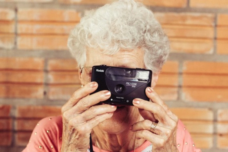 Active senior woman photographing the world around her, symbolizing the preservation of vitality and cognitive functions in older age that can be supported by natural compounds from deer velvet
